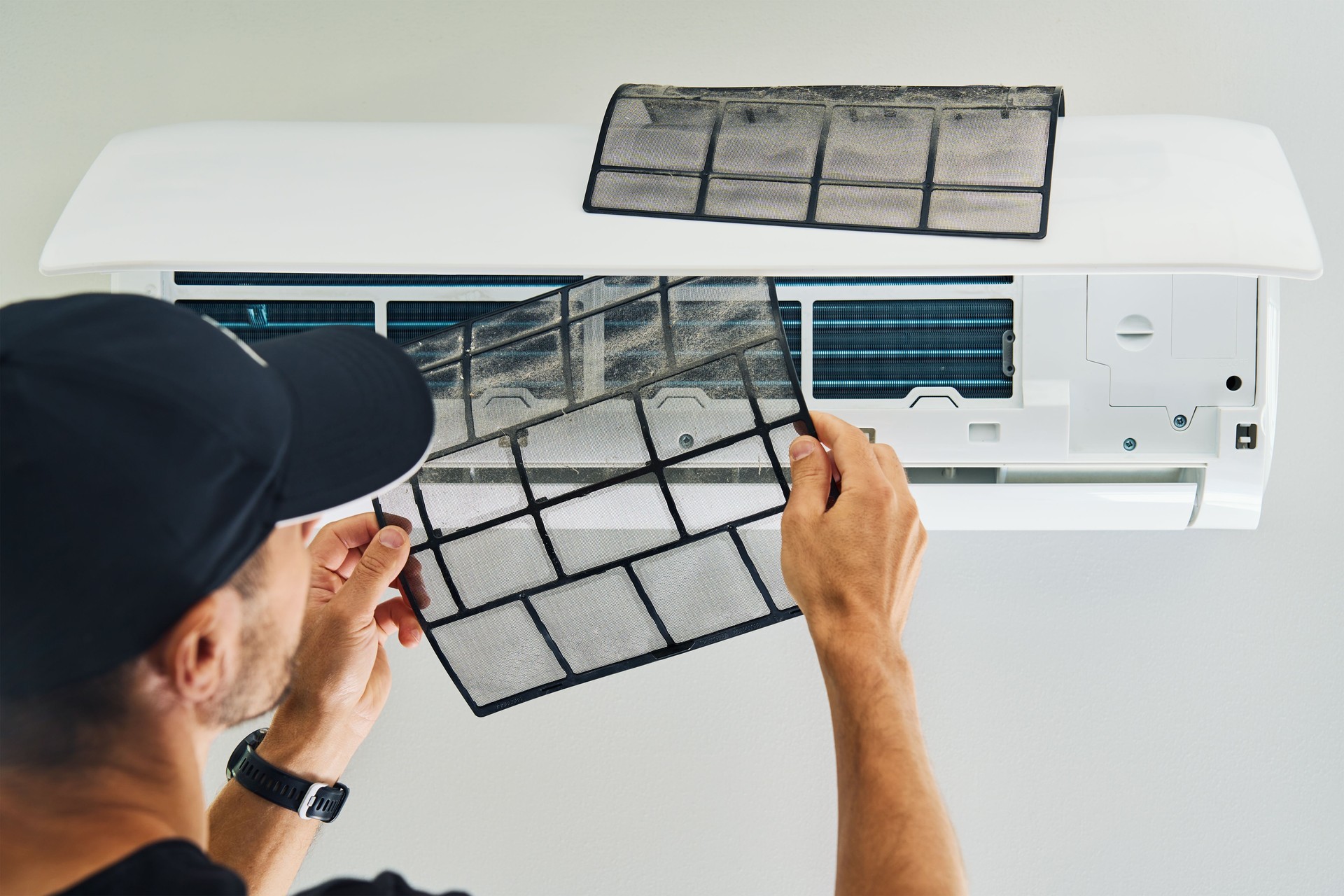 Air conditioner maintenance. Male technician repairing cooling system